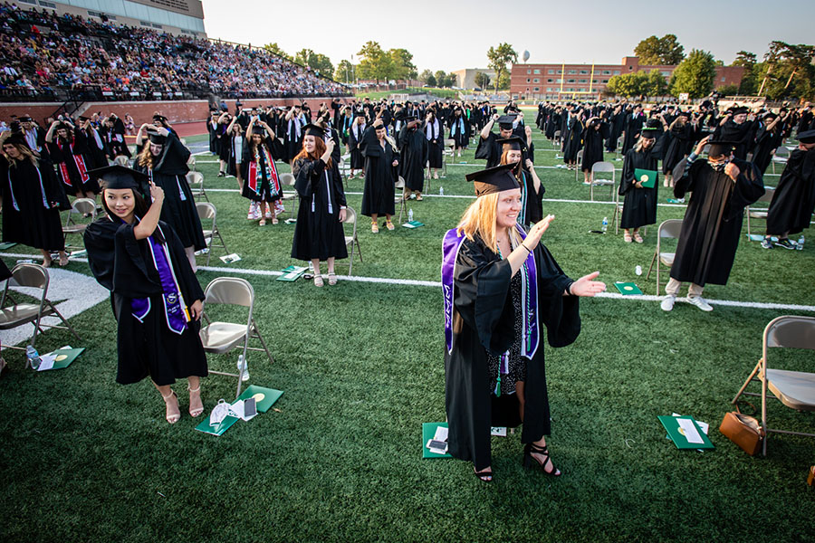 Bachelor's degree candidates turn their tassels after the conferral of their degrees during Northwest's spring commencement ceremony Saturday night at Bearcat Stadium. The celebration honored more than 1,200 students who completed degrees during the University's spring and summer terms. (Photos by Todd Weddle/Northwest Missouri State University)