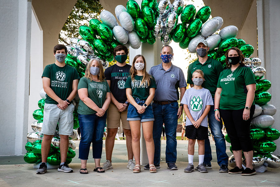 The Liles family of Maryville was recognized as Northwest's Family of the Year during the Homecoming Showcase at the Memorial Bell Tower. Left to right are Caleb Liles, Kristi Rodeman Liles, Jacob Liles, McKenna Liles and Marty Liles, with Cody Kreifels and Allison Kahre Kreifels and their son, Carter Kreifels. (Photo by Todd Weddle/Northwest Missouri State University)