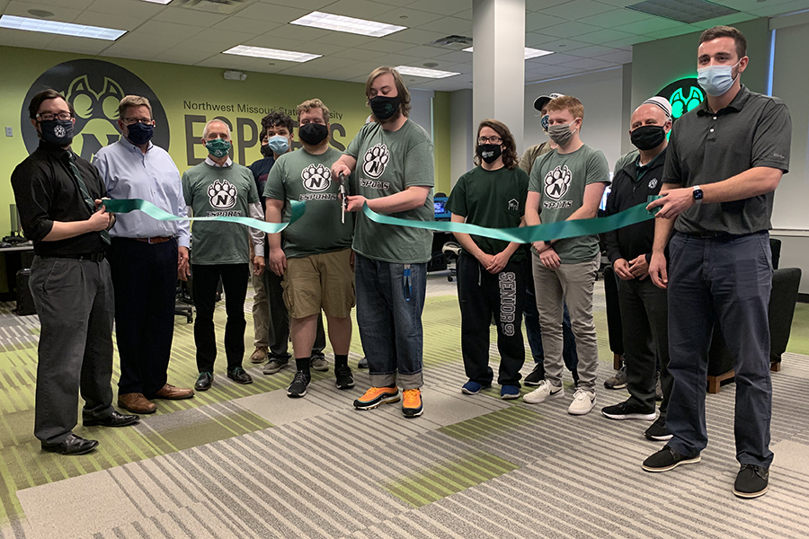 Vincent Sorrentino, the president of the Northwest Esports Club, cut a ribbon Monday to celebrate the opening of an esports room in the J.W. Jones Student Union. He is joined, at left, by Paul Bennett, coordinator of leadership and development; Dr. Matt Baker, vice president of student affairs; Northwest President Dr. John Jasinski; and members of the Northwest Esports Club. At right are Greg Hansen, assistant vice president of student affairs for campus recreation, and Jordan Mehl (holding ribbon), coordinator of sport clubs and competitive sports. (Northwest Missouri State University photos) 