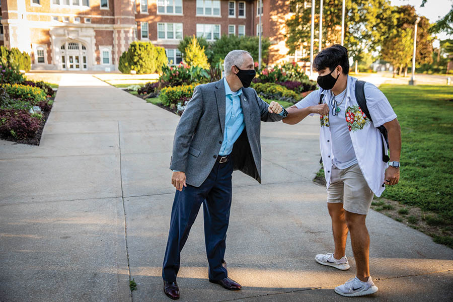 President Jasinski greeted students with elbow bumps as they walked to their first day of classes.