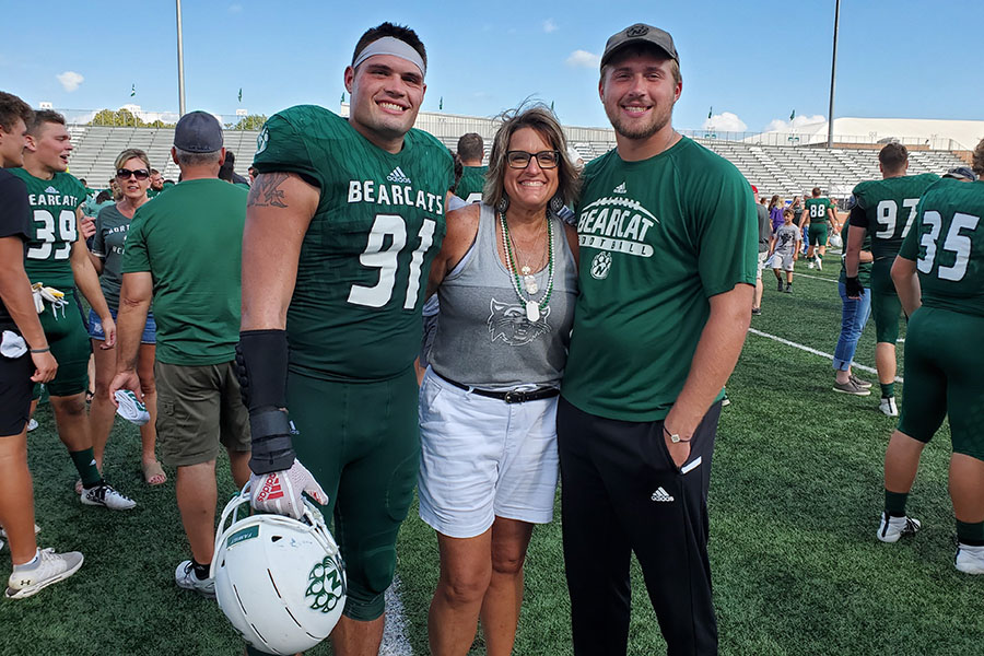 Tammi Pierce is pictured with her sons, Zach (left) and Tyler (right), after a Bearcat football game. Her experience as a Northwest parent led the long-time nurse to complete her Bachelor of Science in Nursing at the University. (Submitted photo)