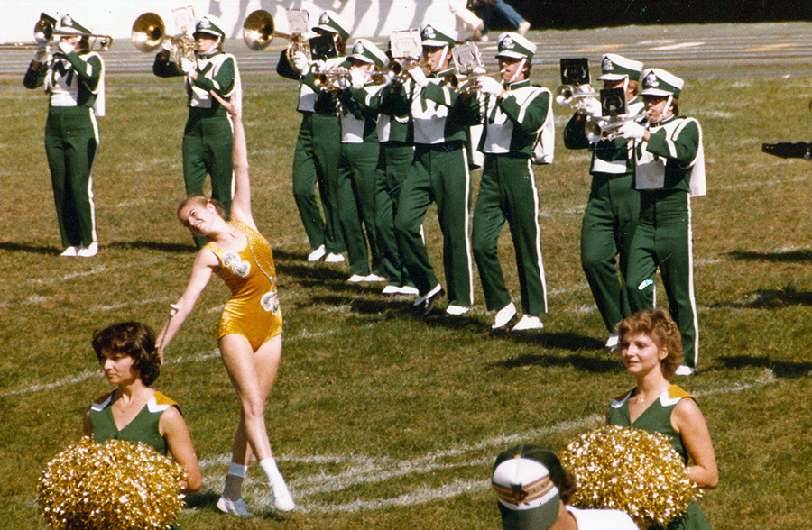 Lori Steiner, as a feature twirler, and her husband, Mike, playing trumpet at the far right, are pictured performing with the Bearcat Marching Band in 1982. Being part of the band had a significant impact on their Northwest experience, and they have established a scholarship honoring that time in their lives as well as the commitment of Lori's mother to support her twirling. (Photos courtesy of Lori and Mike Steiner). 