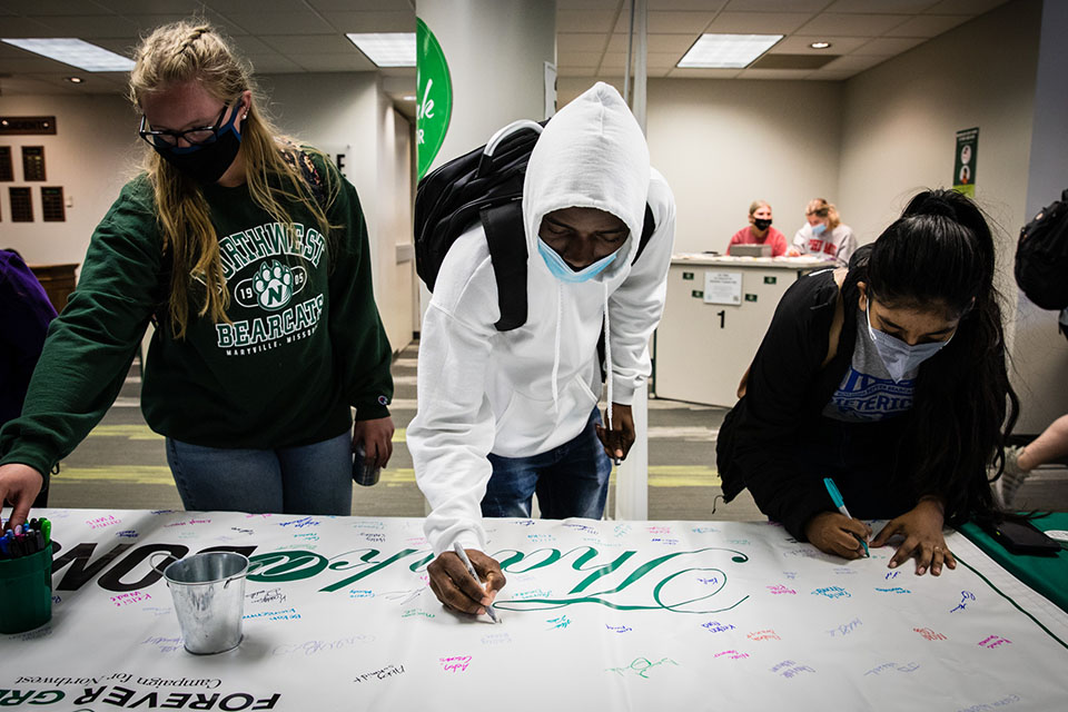 Students signed a banner to thank donors during the University's Thank a Donor Day on Tuesday. The annual day of activities encourages the University community to show appreciation for donors through their participation in a series of activities. (Photo by Brandon Bland/Northwest Missouri State University)