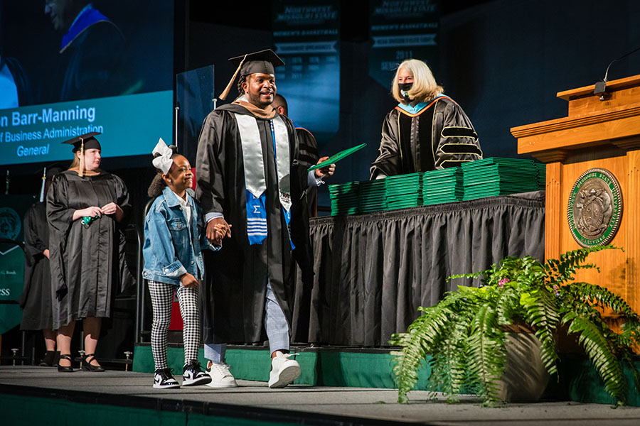 Philon Barr crossed Northwest's commencement stage Saturday afternoon with his daughter. (Photo by Todd Weddle/Northwest Missouri State University)