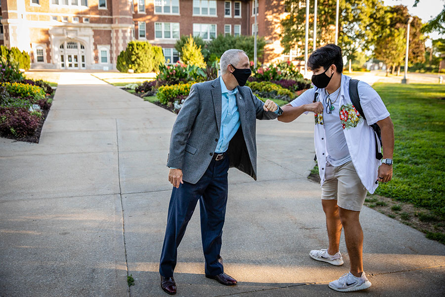 Northwest President Dr. John Jasinski greeted students by bumping their elbows as they walked to classes during the first day of the fall 2020 semester. The University's fall enrollment was the highest in its 115-year history. (Northwest Missouri State University photo)
