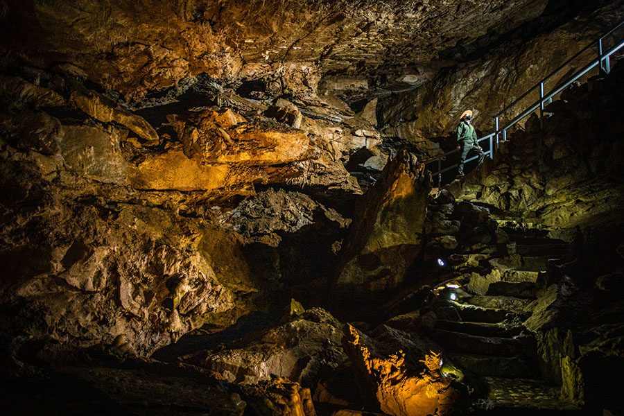 Brett Lang travels a staircase inside Oregon Caves, which features stunning formations shaped over a million years as rain seeped through the Siskiyou Mountains’ forest soil to create one of the world’s few marble caves.