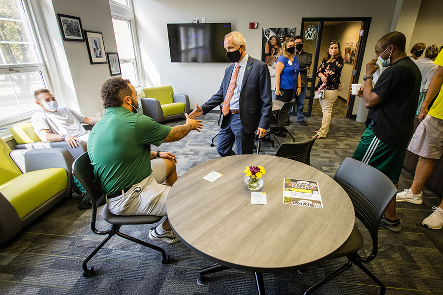 Northwest President Dr. John Jasinski greets students and staff Thursday as he tours the remodeled Office of Diversity and Inclusion.