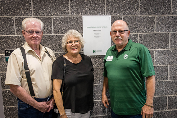 Rob Bolin, right, stands with his parents at the entrance to the Robert Bolin Family Kitchen in Northwest's Agricultural Learning Center. Rob and his wife, Sue, provided $50,000 to support the ALC and dedicated their gift to Rob's parents.