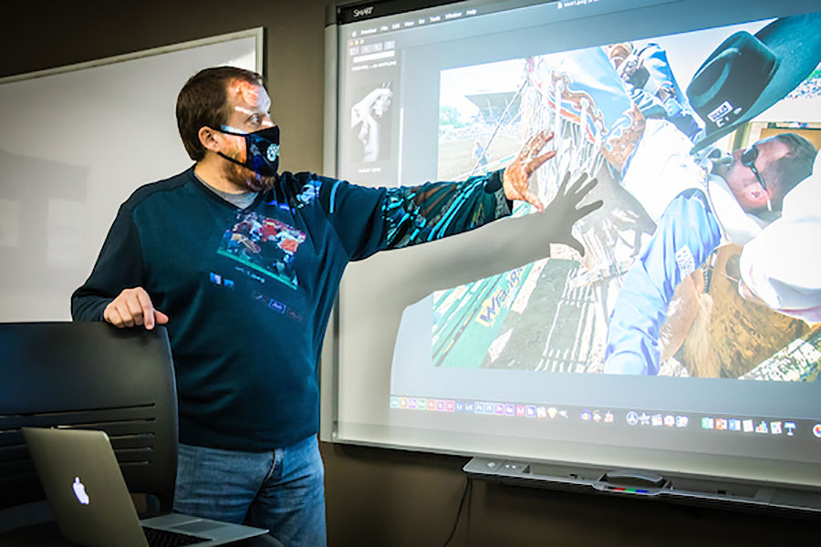 Jason Offutt, a senior instructor of mass media in Northwest's School of Communication and Mass Media, teaches a photography course in Wells Hall. Offutt, who began his professional career in journalism, recently published his 16th book. (Northwest Missouri State University photo)