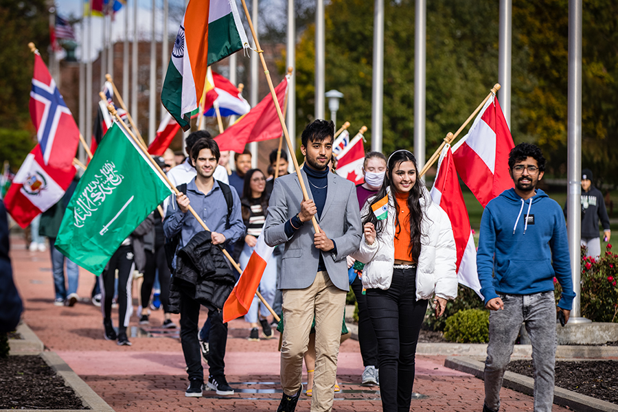 International students carry the flags of their home countries across campus each fall as part of the University's annual International Flag-Raising Ceremony. On Friday, the International Student Organization hosts its annual dinner. (Photo by Todd Weddle/Northwest Missouri State University)  