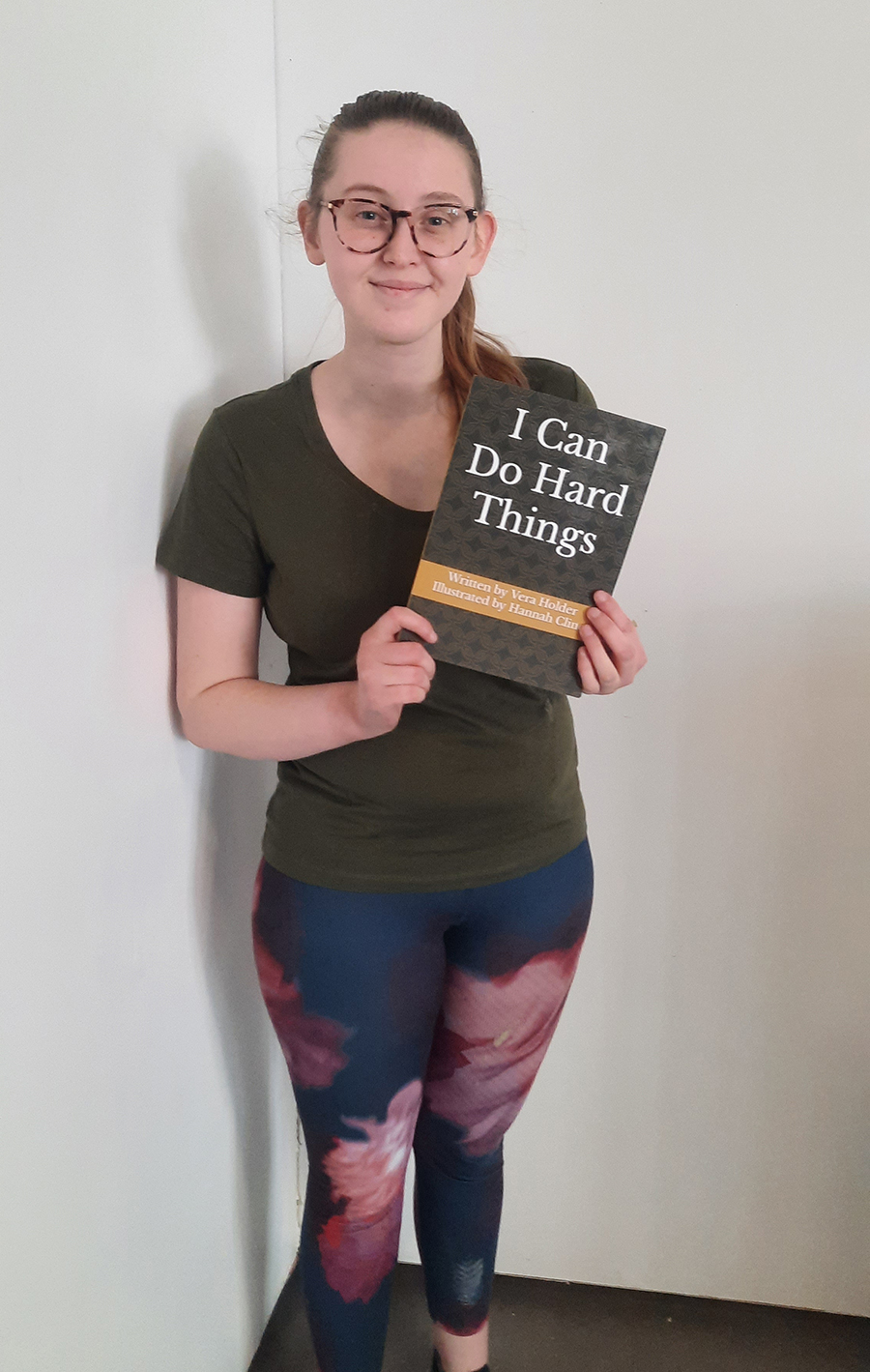 Hannah Cline with a the book she illustrated, titled  “I Can Do Hard Things.” 
