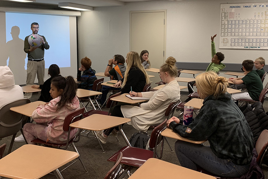 Fairmount Elementary students participated in a general statistics course in Garrett-Strong, where Dr. Taylor Harrison, an assistant professor of mathematics and statistics, had the class pass an inflatable globe to demonstrate the statistical probability of the receivers' index finger landing on the globe's water.  