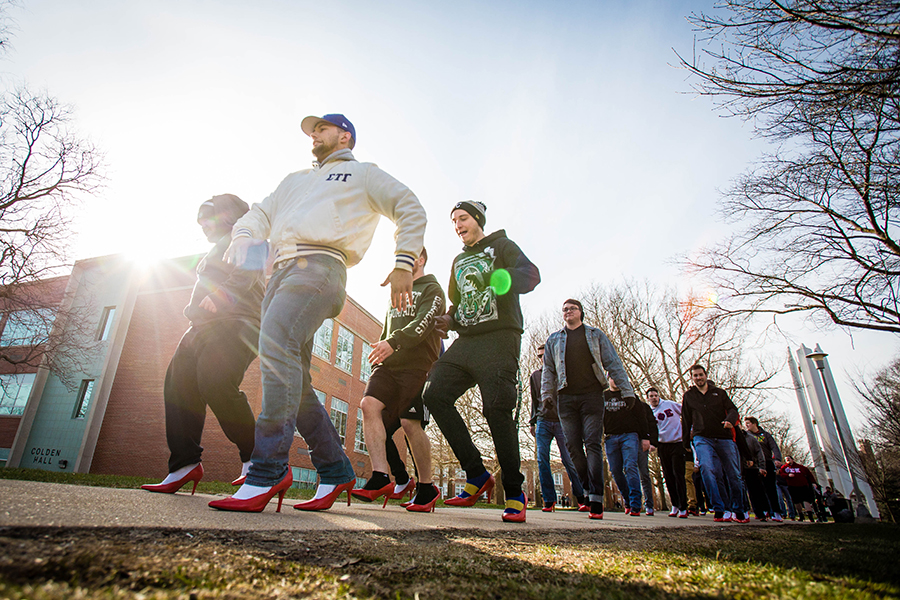 In this 2018 photo, Northwest students walk the campus in high heels to help raise awareness of issues of domestic violence, abuse and sexual assault. The Interfraternity Council will lead the annual walk April 26 as part of University activities in observance of Sexual Assault Awareness Month. (Photo by Todd Weddle/Northwest Missouri State University)