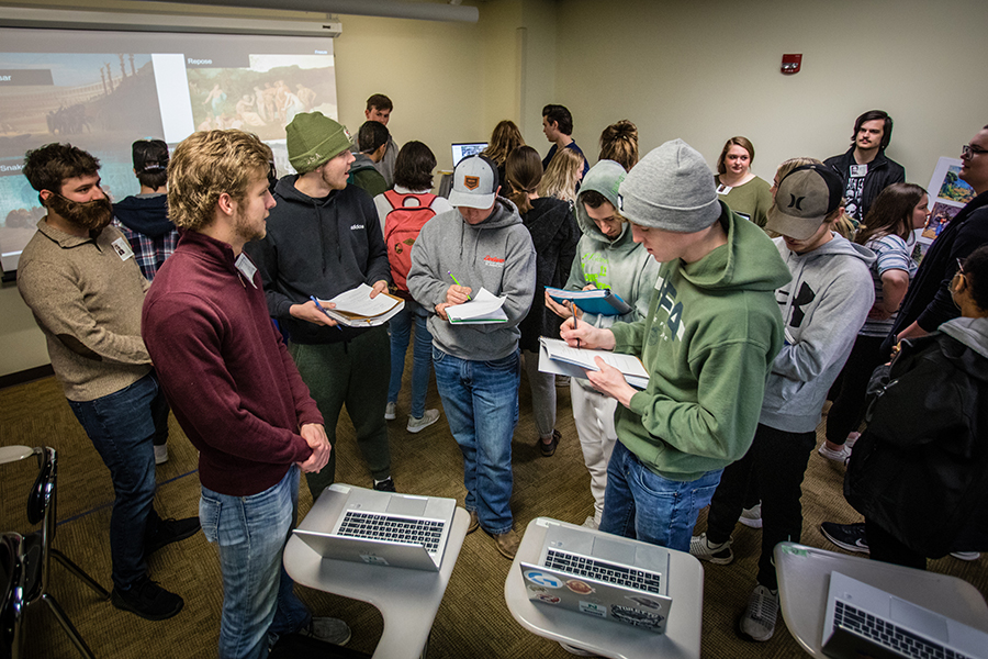 Northwest students crowded around displays of art during a role-playing game recreating the Exposition Universelle of 1889. (Photos by Lauren Adams/Northwest Missouri State University)