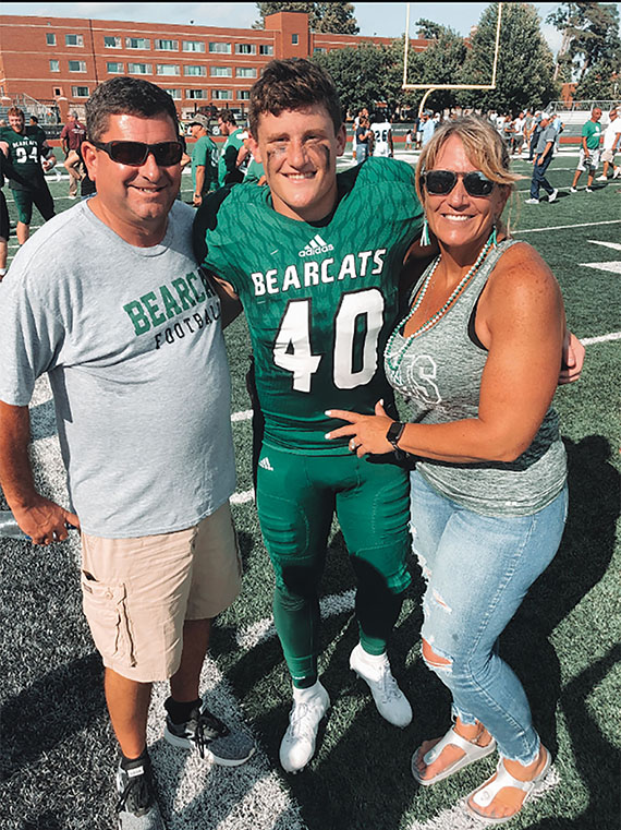 Adrean Eskew is pictured with his parents after a Bearcat football game. (Submitted photo)