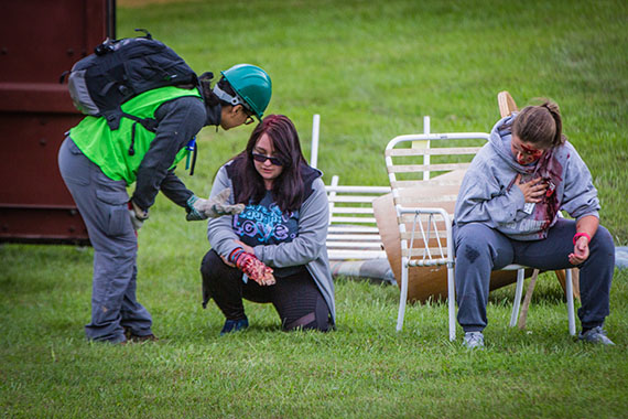 A first responder assists volunteers who are playing the roles of disaster victims during the annual Missouri Hope emergency response field training exercise  at MOERA. Volunteers are needed for this year's training exercise, which is scheduled for Oct. 12-15. (Northwest Missouri State University photo)