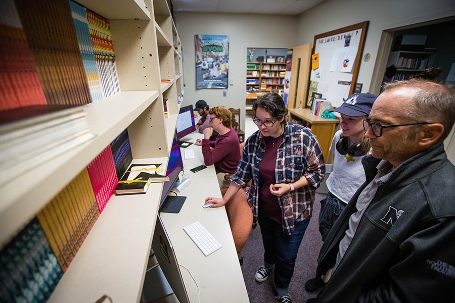 Dr. John Gallaher (at right), a professor of English and co-editor of The Laurel Review, converses with students in the literary arts magazine's Colden Hall office. (Photos by Abigayle Rush/Northwest Missouri State University)