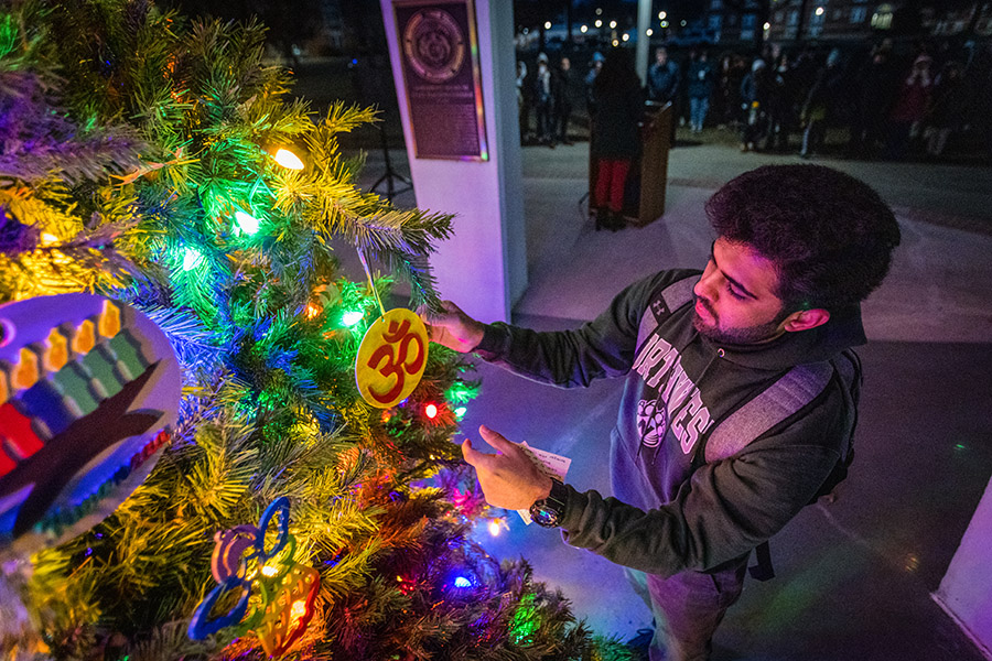 Northwest student Jatin Thakkar hangs a Hindu Om on the University's holiday tree in recognition of his religious culture. (Photos by Lauren Adams/Northwest Missouri State University)