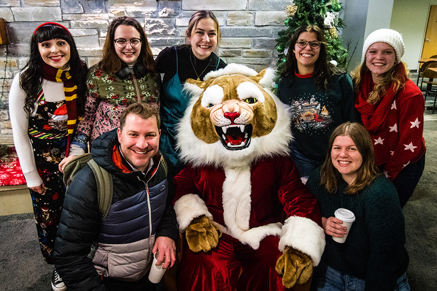 Members of Northwest's Madraliers chamber choir pose for a photo with “Santa Bobby Bearcat.” 