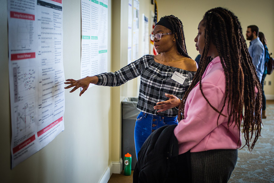 Students discuss a poster presentation during Northwest's 2022 Celebration of Scholars.