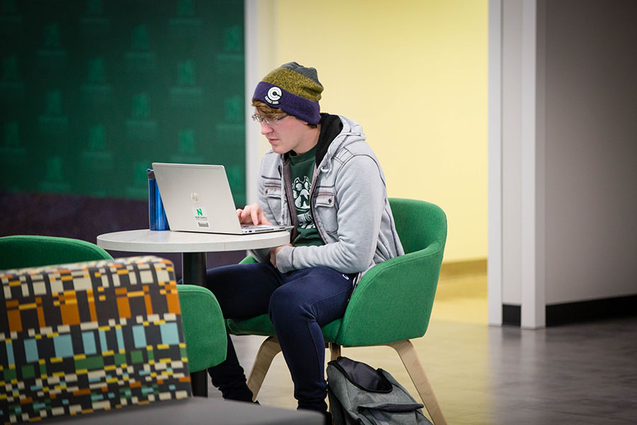 A Northwest student passes time between classes on his University laptop. At Northwest, textbooks and a laptop are included in tuition. (Photo by Abigayle Rush/Northwest Missouri State University)