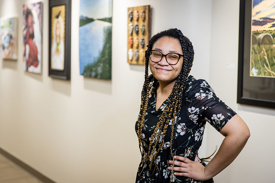 Anaya Walker is the curatorial intern for the “Art of Healing Galleries” exhibition at Mosaic Medical Center-Maryville. (Photo by Lauren Adams/Northwest Missouri State University)