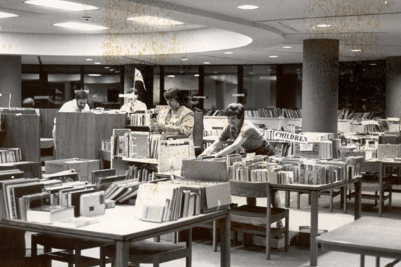 Staff members organize books at the Owens Library after its completion in 1983. (University Archives)