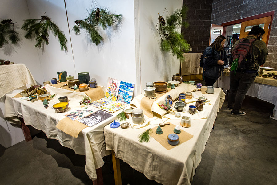 Patrons look over the variety of art available during Northwest's winter art show and sale last December in the  Fire Arts Building. The spring art show and sale is April 21-22. (Photo by Lauren Adams/Northwest Missouri State University)