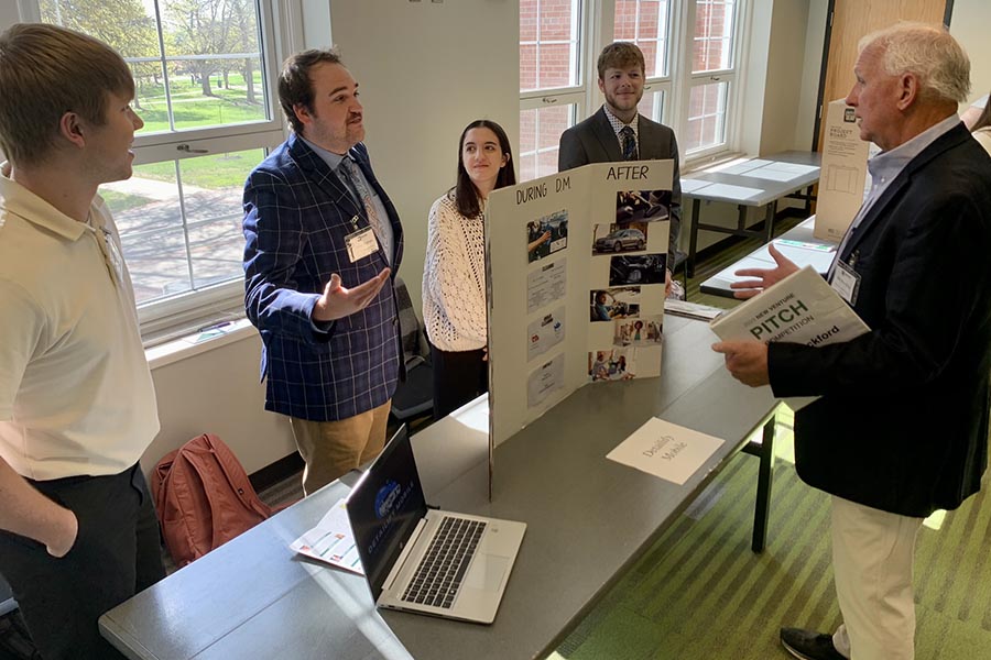 The students comprising Detailfy Mobile pitch their business idea to local businessman and New Venture Pitch judge Jim Blackford. 