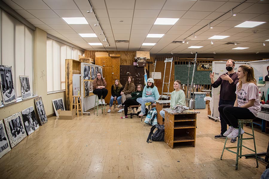 Northwest Professor of Art Armin Muhsam reviews artwork with students during a painting course this spring. 