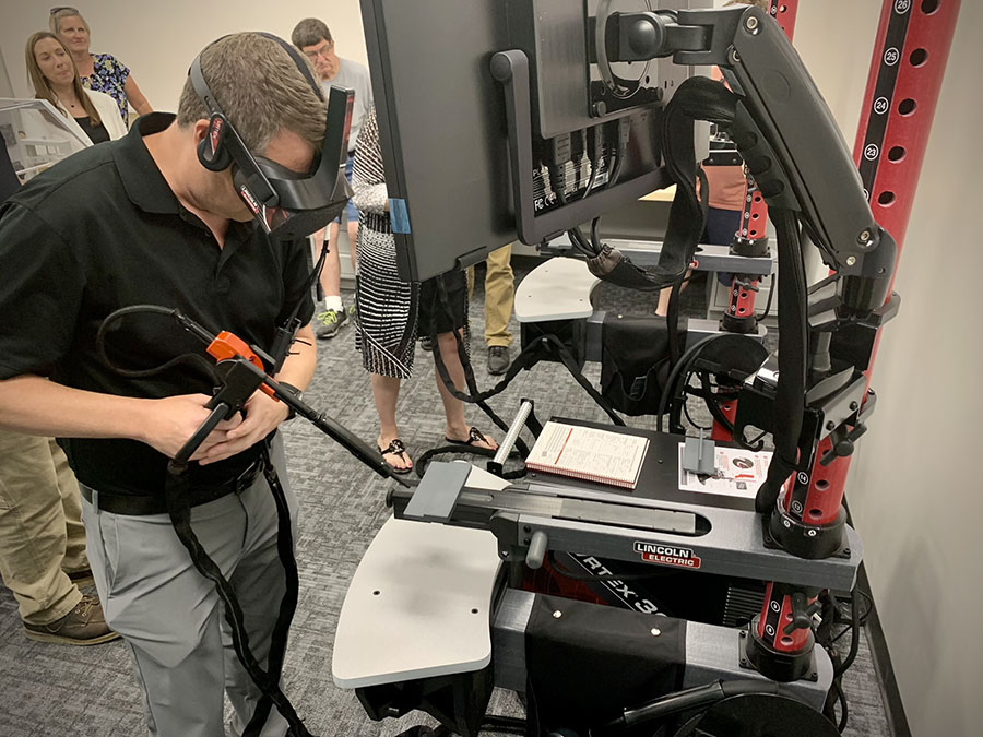 Shad Burner, director of federal initiatives with the Missouri Dept. of Economic Development, practices welding with a simulator in the McKemy Center.