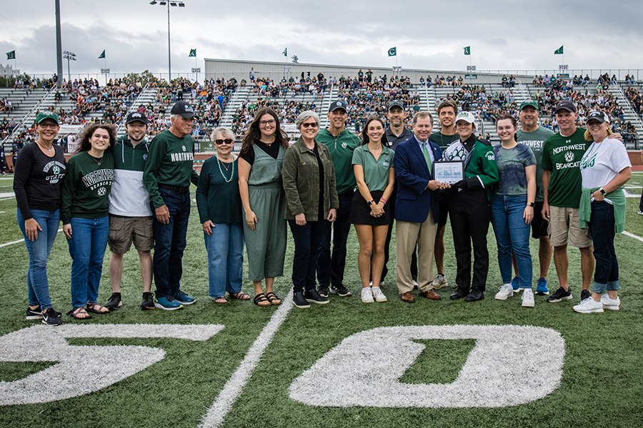 The Norman family includes, left to right, Janne Collins Grover, Eryn Tinsman-Grover, Zach Grover, Gary Collins, Ramona Collins, Rylee Norman, Geri Collins Norman, Kevin Norman, Student Senate President Elizabeth Motazedi, Director of Alumni Relations Duane Havard, Northwest President Dr. Lance Tatum, Dillon Grover, Shelby Norman, Kinsey Collins, Kevin Grover, Brad Collins and Julie Callahan Collins. (Photo by Lauren Adams/Northwest Missouri State University)