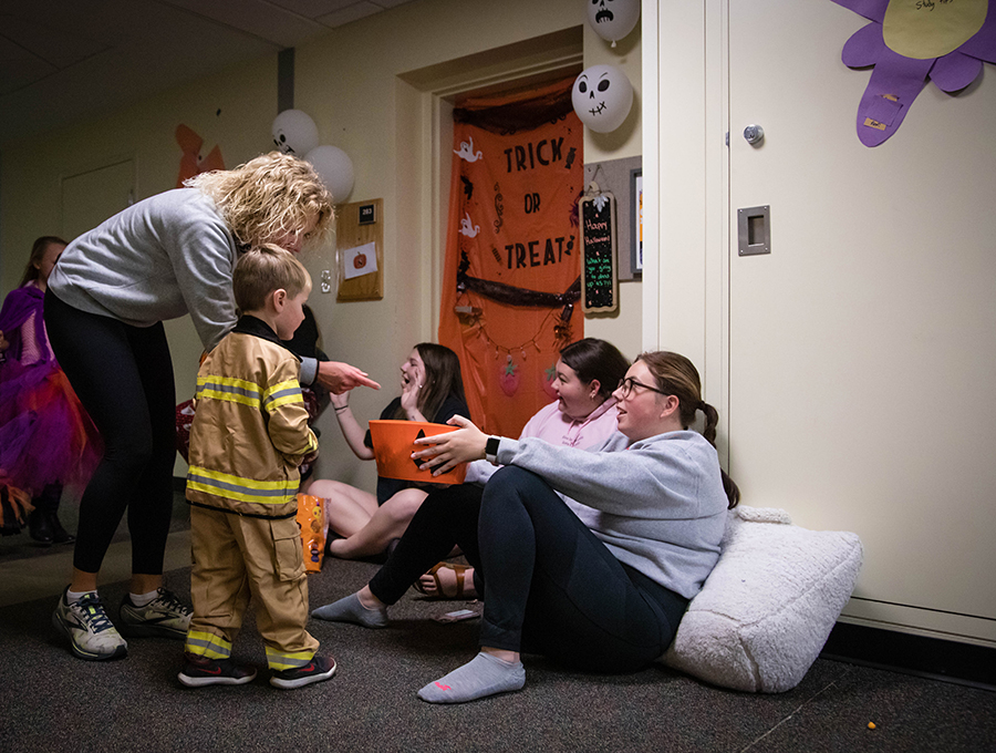 Northwest students greet families at the door of their residence hall room during last year's trick-or-treating event. (Northwest Missouri State University photo)  