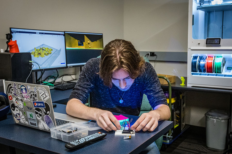 Sean Coyle, a senior computer science major from Elk Point, South Dakota, works with a microcontroller connected to addressable LEDs, in the School of Computer Science and Information Systems' makerspace. (Photo by Chandu Ravi Krishna/Northwest Missouri State University)