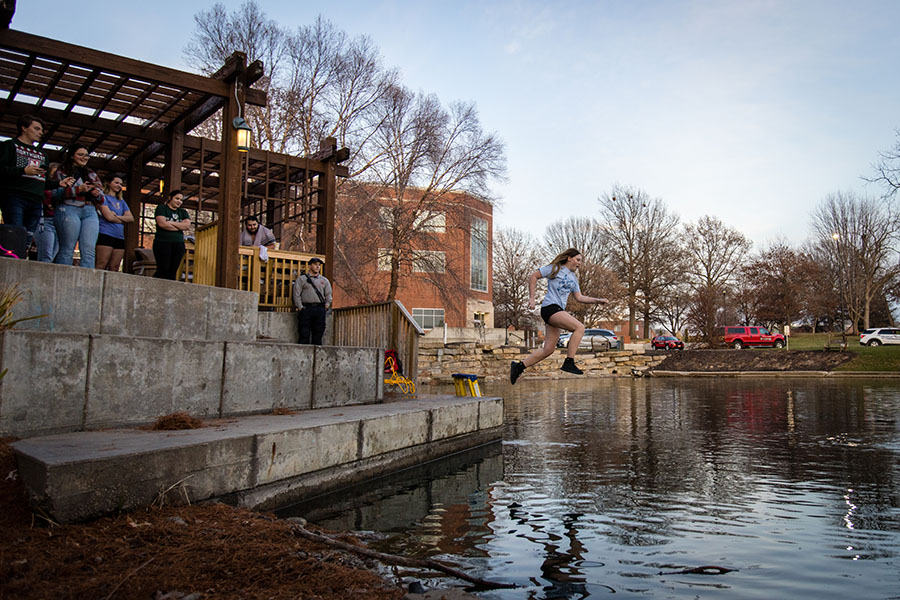 Caitlin Claypole takes her turn jumping into Colden Pond during Thursday's Colden Pond Plunge.