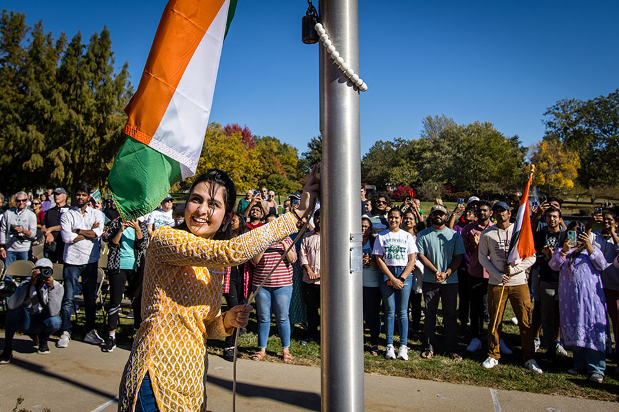 A student from India raises her native country's flag during Northwest's annual International Flag-Raising Ceremony, which celebrates the University's international students and diversity each fall. (Photo by Lauren Adams/Northwest Missouri State University) 