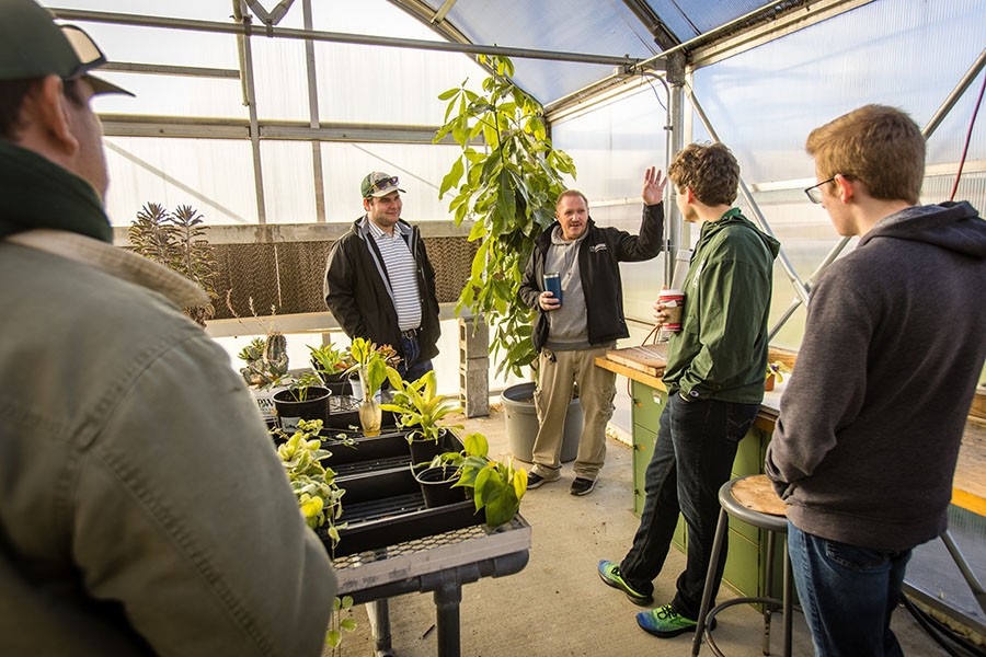 Students in Northwest's Internet of Things course talk with Bryan Freemyer, an arboretum specialist at the University, about the sensor platform they set up inside the Horticulture Complex to better monitor plant life there. (Photos by Lauren Adams/Northwest Missouri State University)