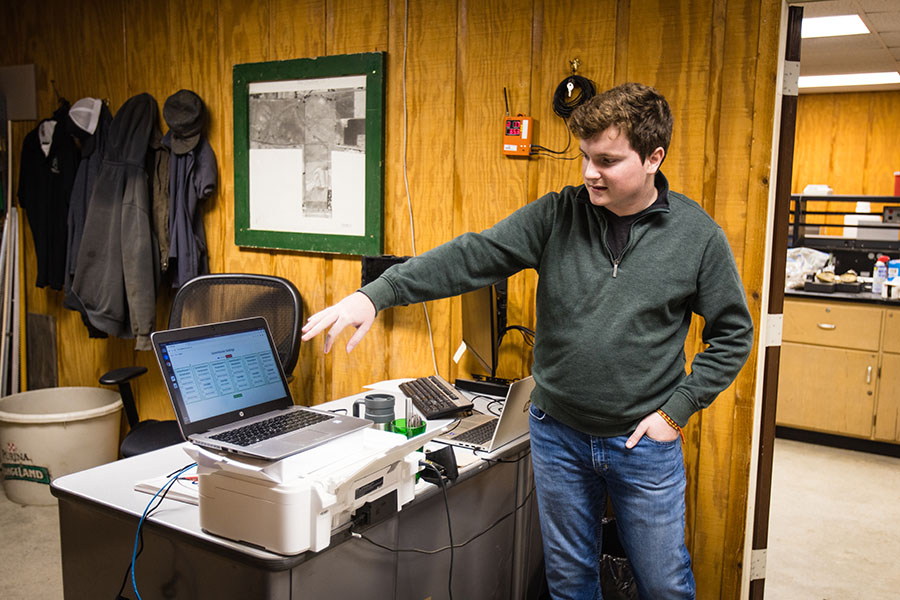 Parker Christy, a senior computer science major from Humphreys, Missouri, describes how a base station receives data to help Horticulture Complex staff monitor conditions inside greenhouses.  