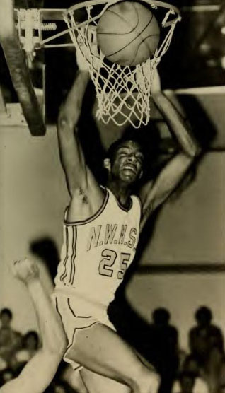 Tony White attempts a dunk in a game during the 1983-84 men's basketball season. (1984 Tower yearbook photo)