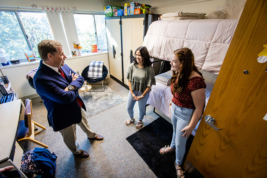 President Tatum conversed with first-year early childhood education majors Briana Crites and McKenna Black after they won a residence hall room-decorating contest in October. (Photo by Todd Weddle/Northwest Missouri State University)