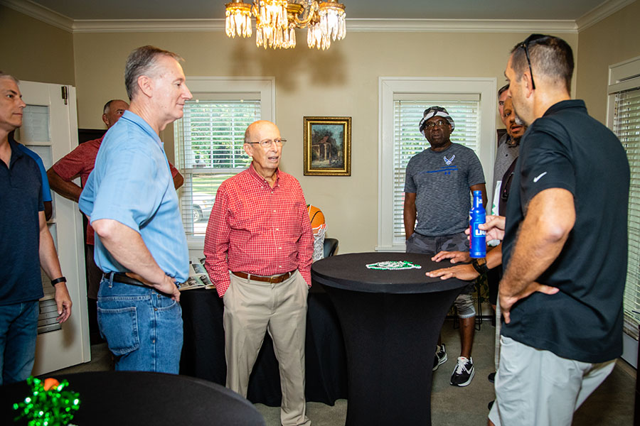 Lionel Sinn (middle) reunited with some of his former players during an evening reception last fall at the Michael L. Faust Center for Alumni and Friends. (Photo by Chandu Ravi Krishna/Northwest Missouri State University)