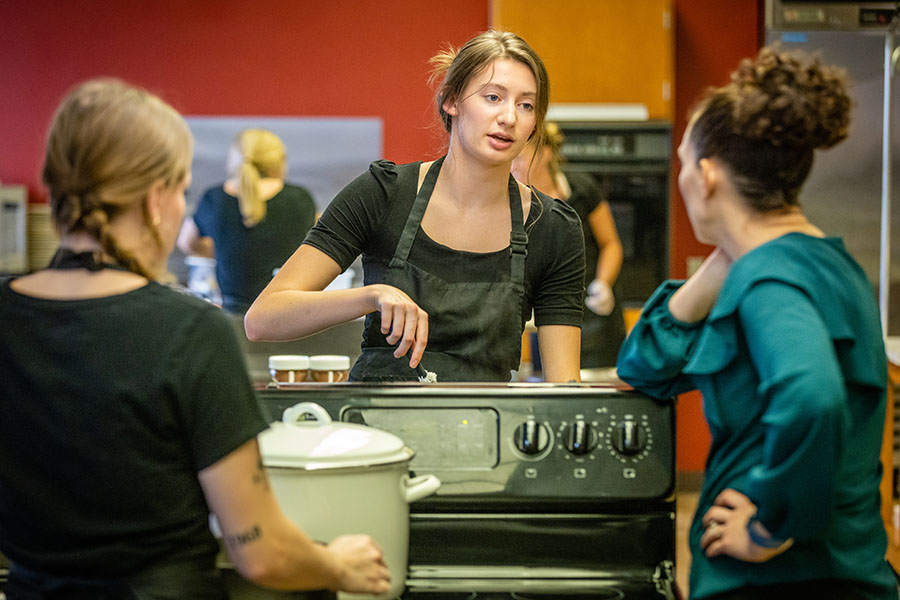 Kelli Wilmes, right, provides instruction to Northwest students during last fall's Friday Night Café program, which provides profession-based experience related to preparing and serving internationally inspired meals for guests. (Photos by Todd Weddle/Northwest Missouri State University)