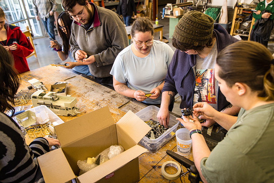 Students picked from a variety of plastic model pieces and parts to begin creating their sculptures.
