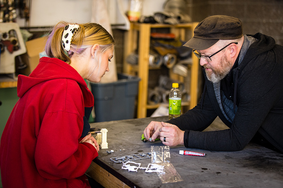 Kuksi assisted Cleo Wills, left, with assembling the varied parts of her sculpture.