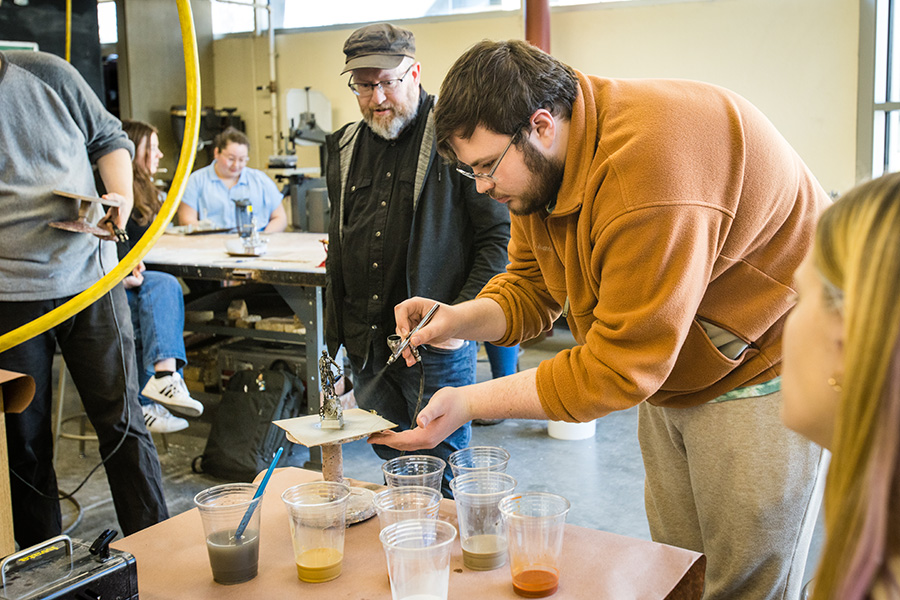 Curtis Pestel used an airbrush to finish his sculpture with Kuksi's guidance. 