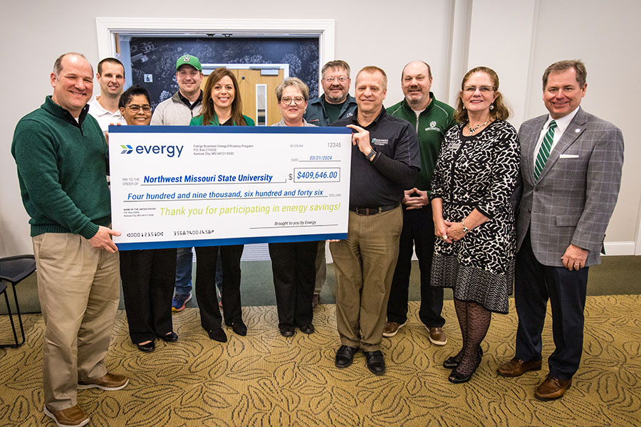 Representatives of Evergy on Thursday presented Northwest with a rebate check for its its energy-efficient projects during the last five years. Left to right are Evergy contractor Brett Sharp; Derek DeMott, capital programs engineer at Northwest; Melody Knoch, product manager at Evergy; Tyler Steele, project manager at Northwest; Carrie Koelzer, lead customer solutions manager at Evergy; Stacy Carrick, vice president of finance and administration at Northwest; Troy Brady, mechanical, electrical and plumbing supervisor at Northwest; Scott Kuhlemeyer, director of capital programs at Northwest; Jason Klindt, a member of Northwest’s Board of Regents and senior director of external affairs at Evergy; Roxanna Swaney, the chair of Northwest’s Board of Regents; and Northwest President Dr. Lance Tatum. (Photo by Lauren Adams/Northwest Missouri State University)