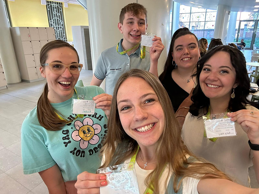 Students Rachel Radcliff, Jonathan Rohr, Jenna Cotter, Abbie Johnson and Avry Asby show off their official name badges after checking in at the Loris Malaguzzi Center for their first day of learning about the Reggio Emilia philosophy.
