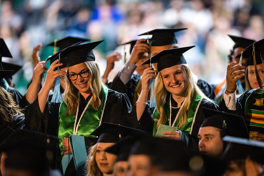 Northwest graduates turn their tassels after the conferral of their degrees on Friday.