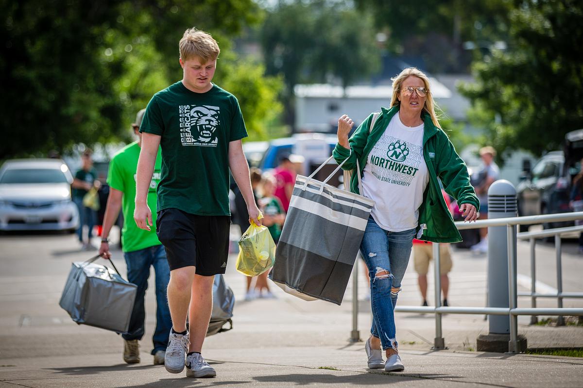 Move-in day is a family affair as a young man and a loved one is seen carrying in items