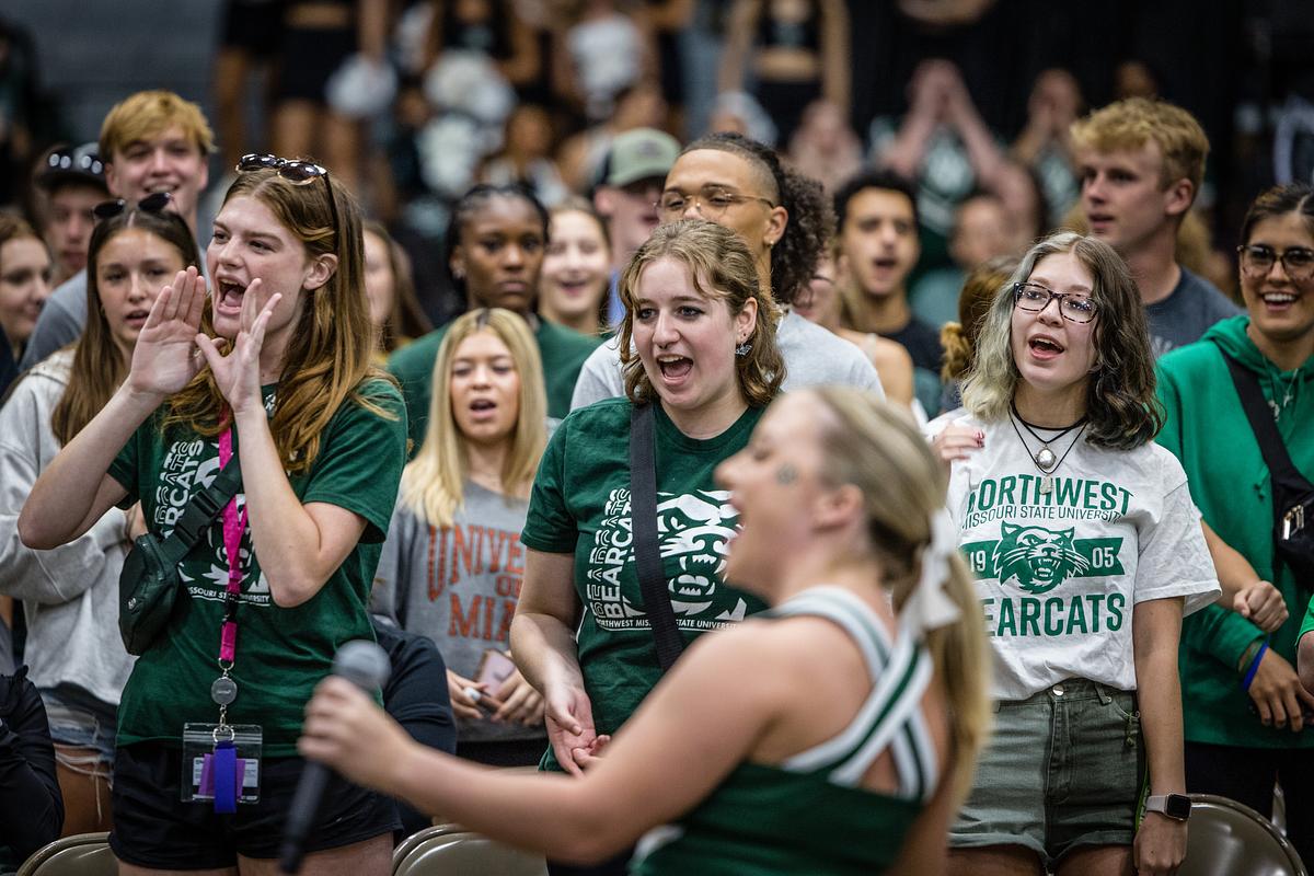 Students join in with the Bearcat Cheerleaders during a cheer at Convocation